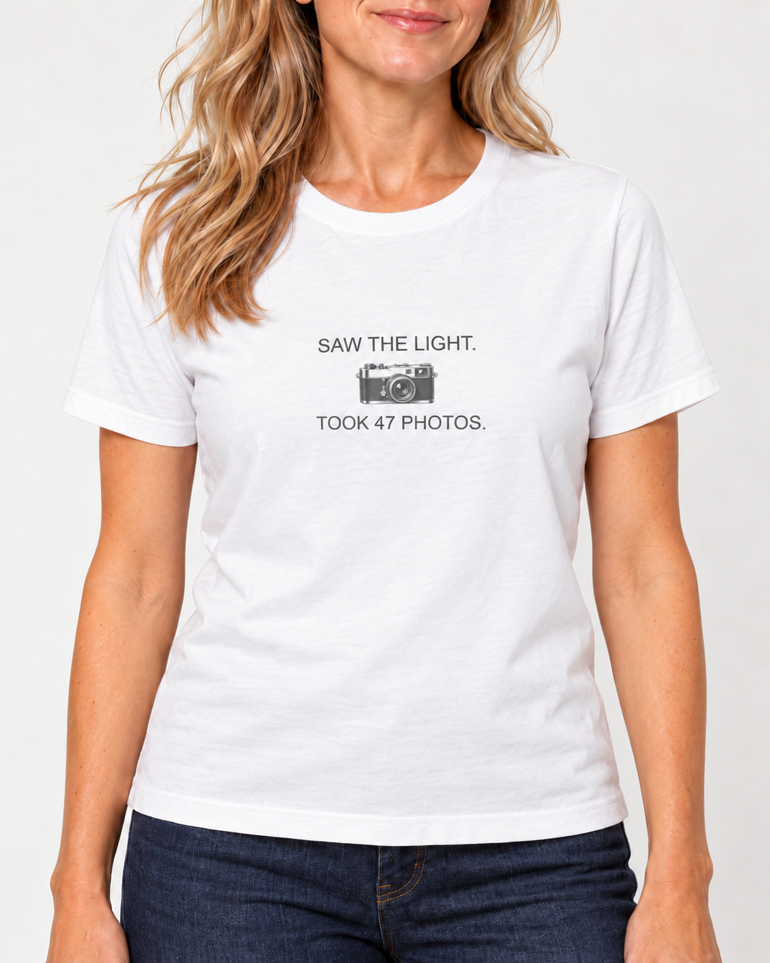 Collar-to-hip view of the White Bella+Canvas6400 women’s relaxed-fit tee, showing the original camera, Saw the Light Took 47 Photos print and shorter untucked hem.