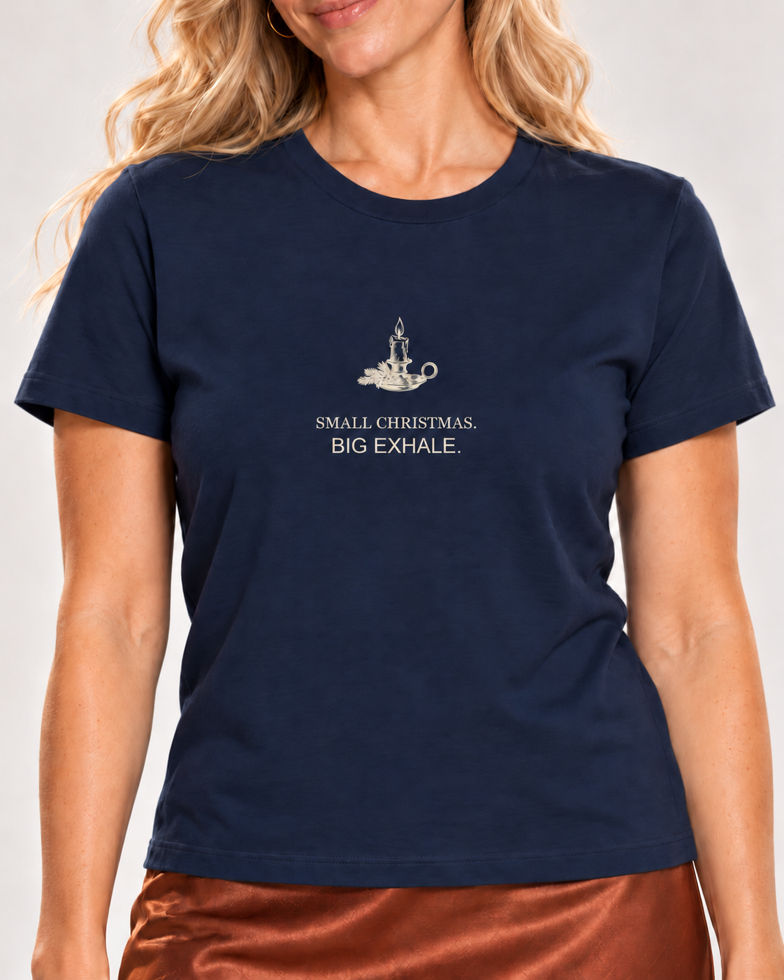 Close view of the pale candle and fir illustration with Small Christmas. Big Exhale. lettering on the Navy Bella+Canvas 6400 women’s relaxed-fit tee.