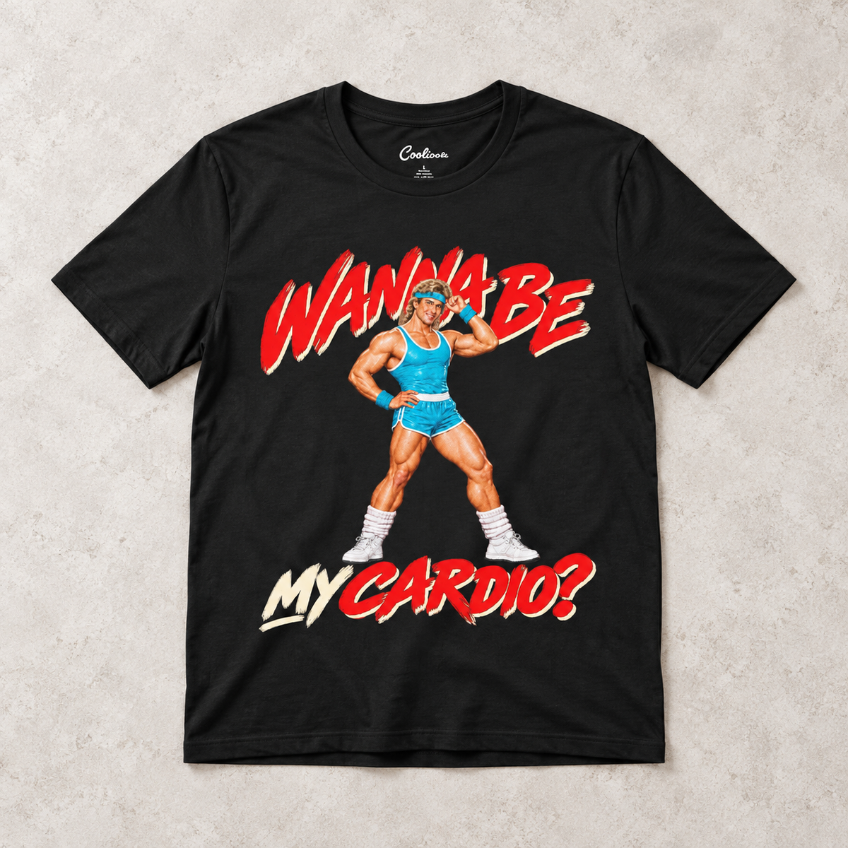Black Wanna Be My Cardio Bella+Canvas 3001 tee, overhead flat lay showing the retro male aerobics graphic.