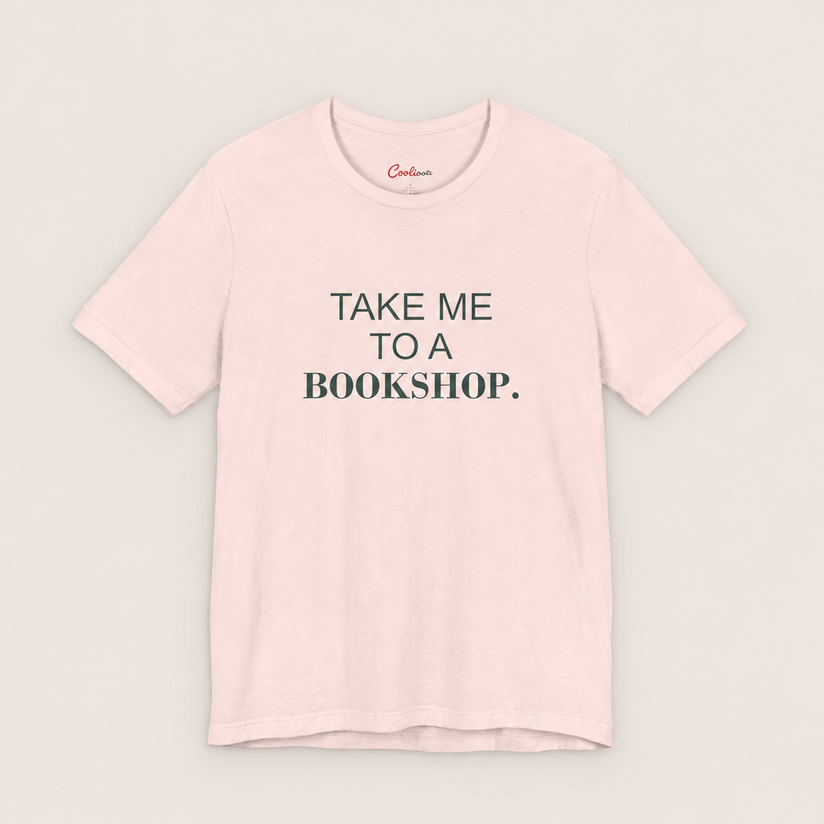 TAKE ME TO A BOOKSHOP. Bella+Canvas3001 T-shirt in Soft Pink, front flat lay.