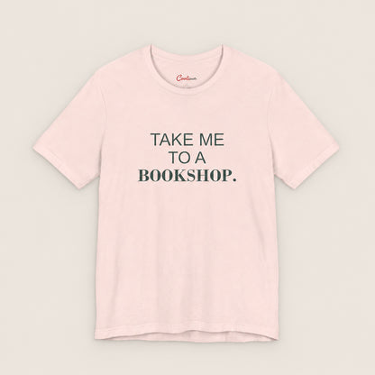 TAKE ME TO A BOOKSHOP. Bella+Canvas3001 T-shirt in Soft Pink, front flat lay.
