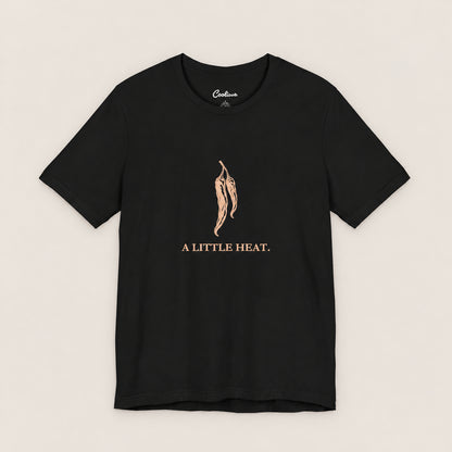 A LITTLE HEAT. Bella+Canvas3001 T-shirt in Black, front flat lay.