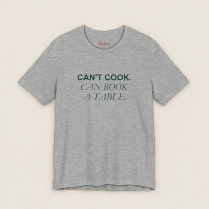 Can't Cook, Can Book a Table Bella+Canvas 3001 T-shirt in Athletic Heather, front flat lay.