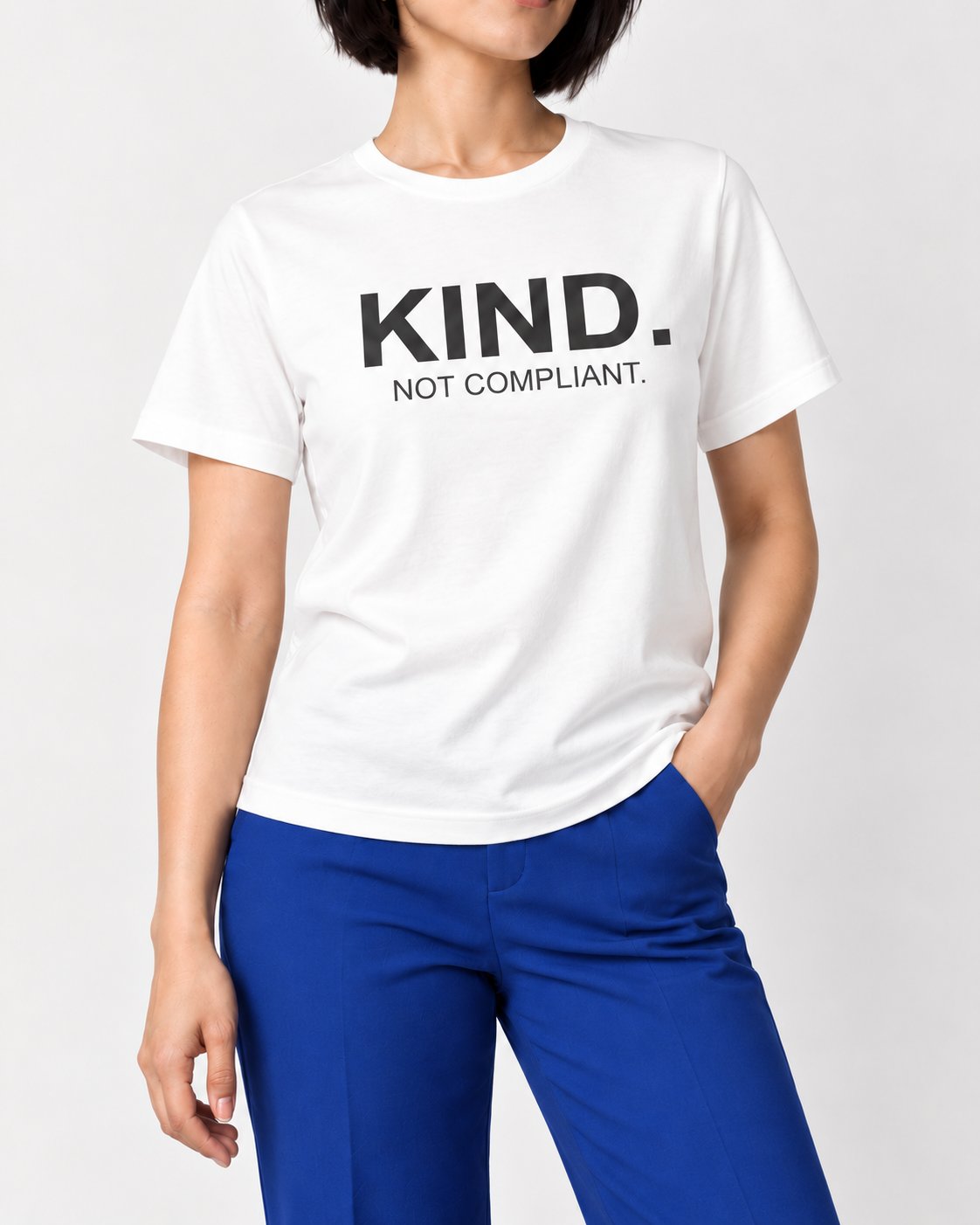 Close-up of Mina wearing the White A Kind Heart. A Firm Line tee, showing the front print and crewneck fit.
