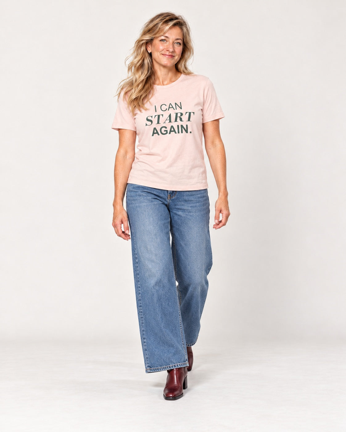 Elena wearing the Soft Pink I CAN START AGAIN. Bella+Canvas 3001 tee — full-length natural studio outfit