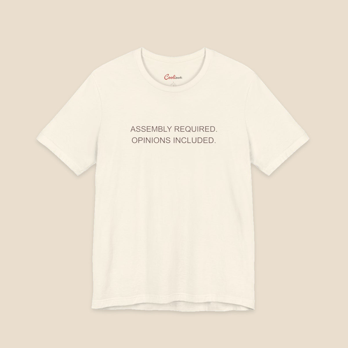 Natural Bella+Canvas 3001 T-shirt with Assembly Required. Opinions Included. printed in two clean sans-serif lines.