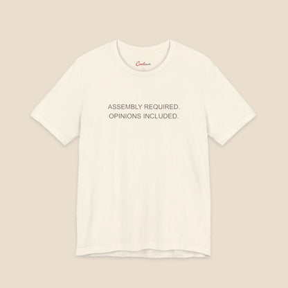 Natural Bella+Canvas 3001 T-shirt with Assembly Required. Opinions Included. printed in two clean sans-serif lines.