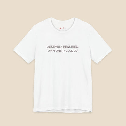 White Bella+Canvas 3001 T-shirt with Assembly Required. Opinions Included. printed in two clean sans-serif lines.