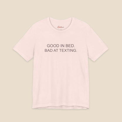 Soft Pink Good In Bed Bad At Texting Bella+Canvas 3001 tee, full flat lay