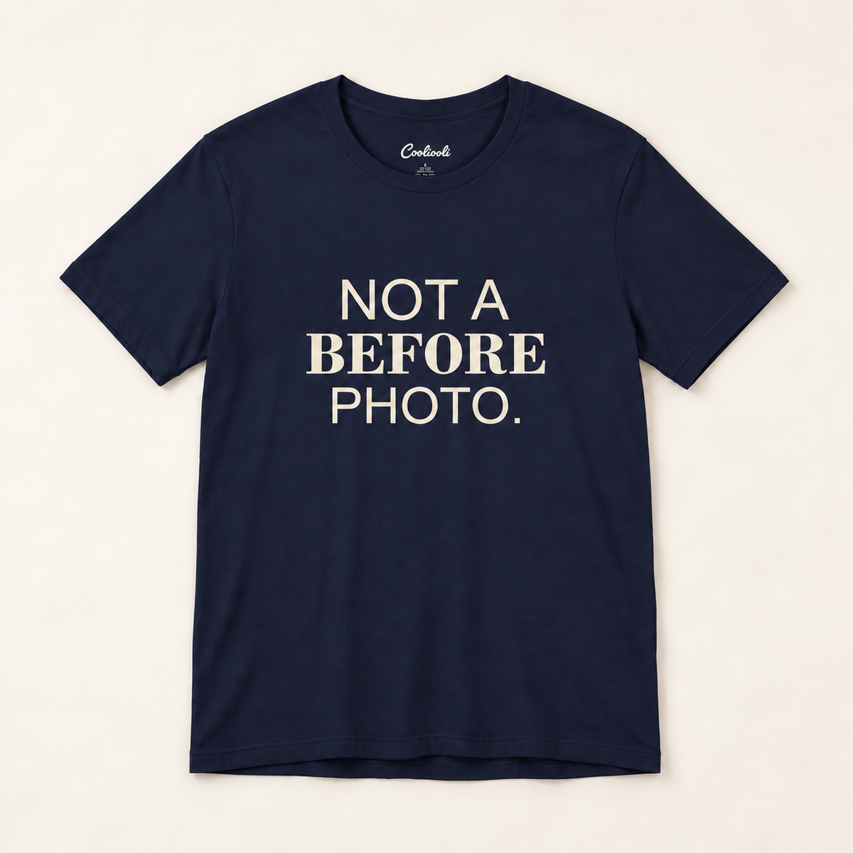 NOT A BEFORE PHOTO. Bella+Canvas 3001 tee in Navy, overhead view on a plain warm neutral studio background