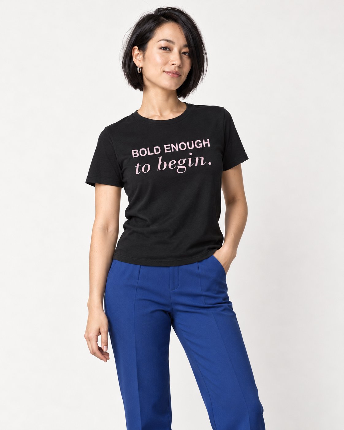 Mina wearing the Black Her Next Chapter Starts Here. Bella+Canvas 3001 tee — natural studio portrait