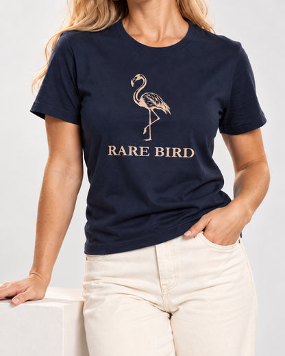 Chloe wearing the Navy RARE BIRD Bella+Canvas 3001 tee — collar-to-hip studio detail with print following fabric folds