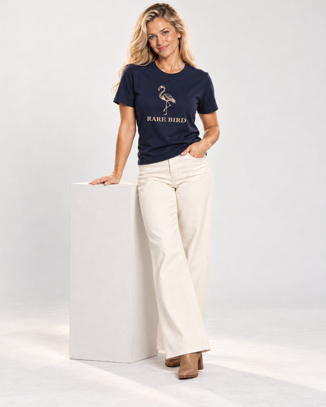 Chloe wearing the Navy RARE BIRD Bella+Canvas 3001 tee — full-length natural studio outfit