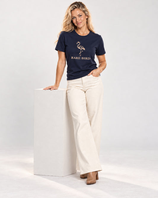 Chloe wearing the Navy RARE BIRD Bella+Canvas 3001 tee — full-length natural studio outfit