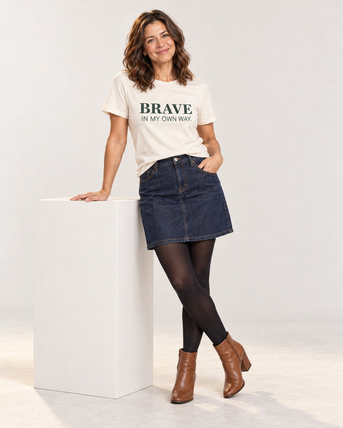 Sophie wearing the Natural BRAVE IN MY OWN WAY. Bella+Canvas 3001 tee — full-length natural studio outfit