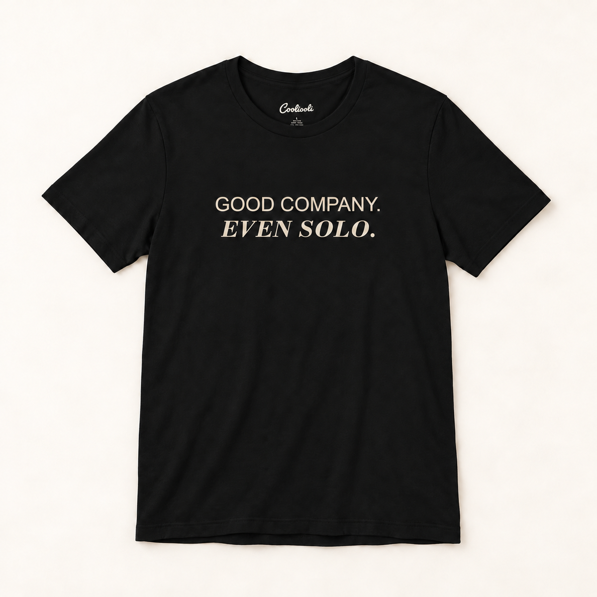 GOOD COMPANY. EVEN SOLO. Bella+Canvas 3001 tee in Black, overhead view on a plain warm neutral studio background
