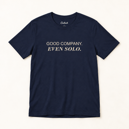 GOOD COMPANY. EVEN SOLO. Bella+Canvas 3001 tee in Navy, overhead view on a plain warm neutral studio background