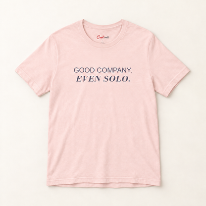 GOOD COMPANY. EVEN SOLO. Bella+Canvas 3001 tee in Soft Pink, overhead view on a plain warm neutral studio background