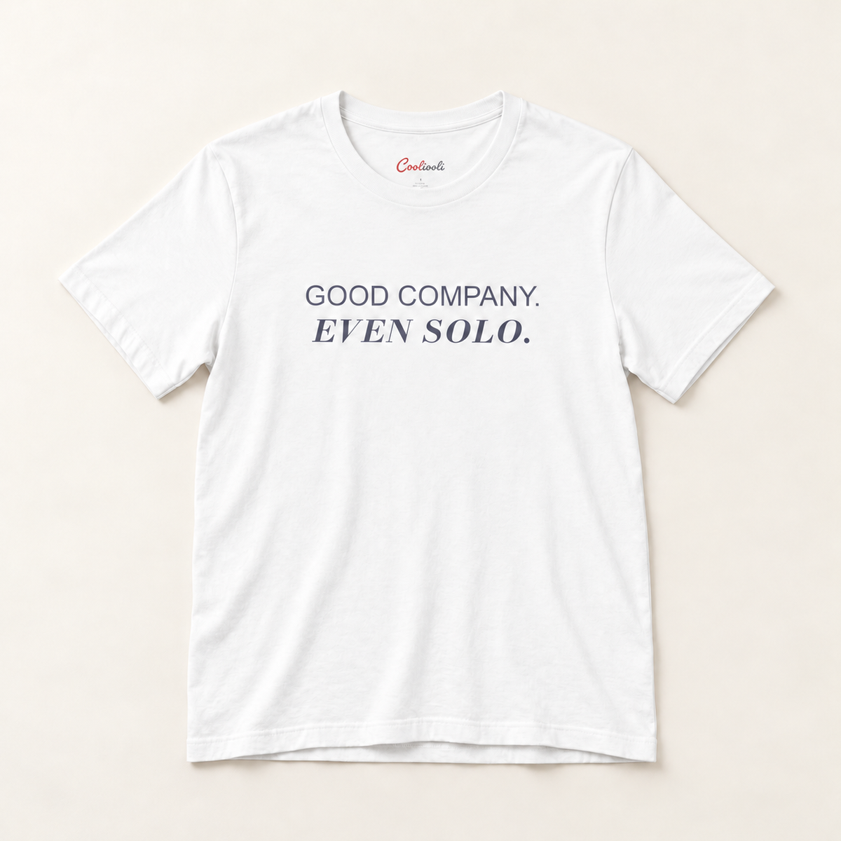 GOOD COMPANY. EVEN SOLO. Bella+Canvas 3001 tee in White, overhead view on a plain warm neutral studio background