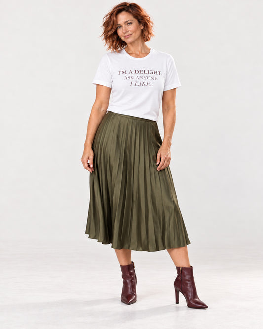 Sienna wearing the white I'm a Delight T-shirt with an olive pleated skirt and burgundy boots