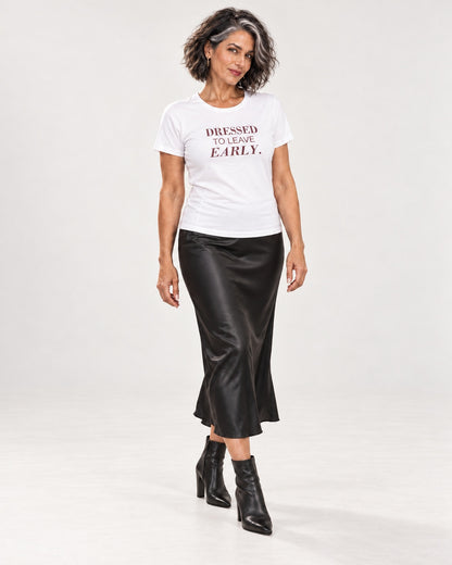Freya wearing the White DRESSED TO LEAVE EARLY. Bella+Canvas 3001 tee — full-length natural studio outfit