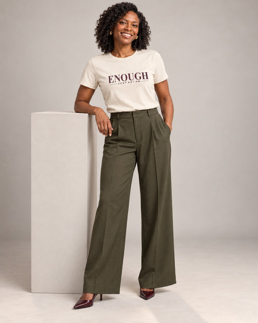 Amara wearing Nothing to Prove. Natural Bella+Canvas 3001 T-shirt with Enough / Just as I am lettering, wide-leg trousers and heels in a professional studio.