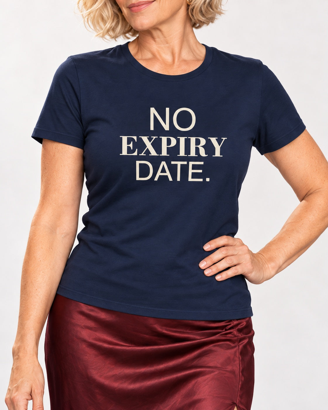 Claudia wearing the Navy NO EXPIRY DATE. Bella+Canvas 3001 tee — collar-to-hip print detail