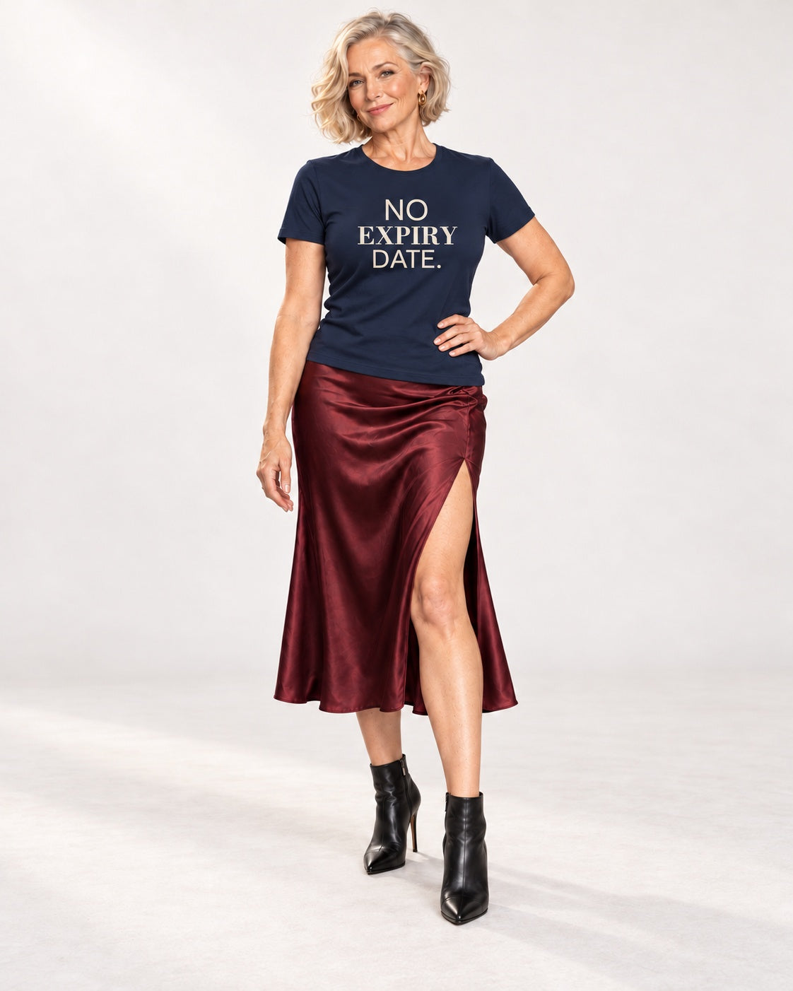 Claudia wearing the Navy NO EXPIRY DATE. Bella+Canvas 3001 tee — full-length natural studio outfit
