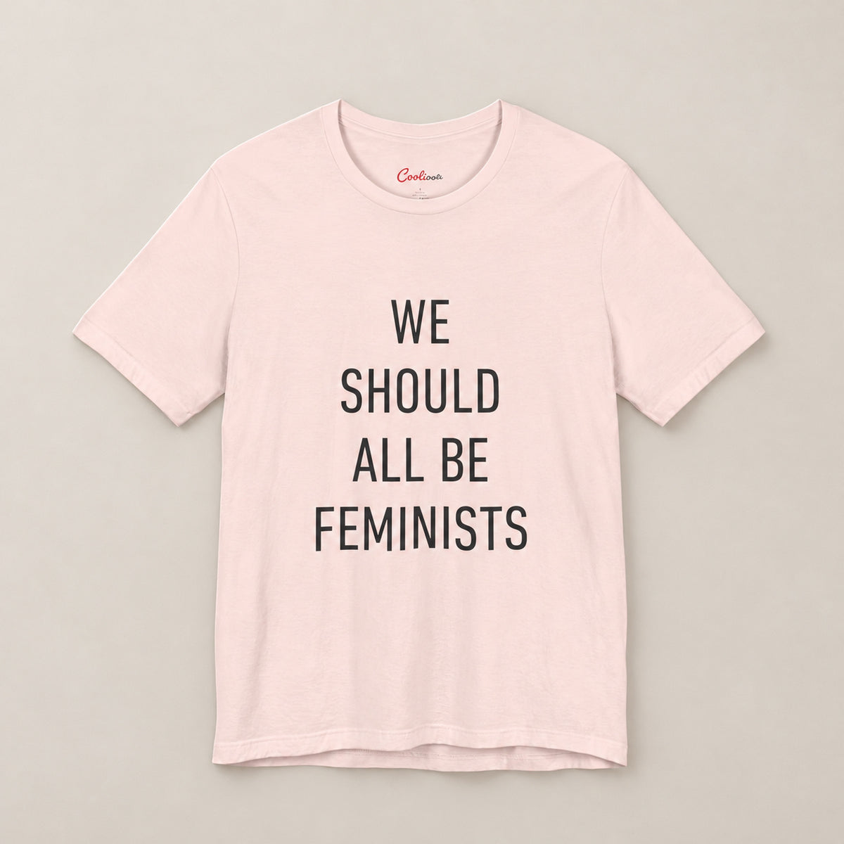 We Should All Be Feminists Bella+Canvas 3001 T-shirt in Soft Pink, front flat lay.