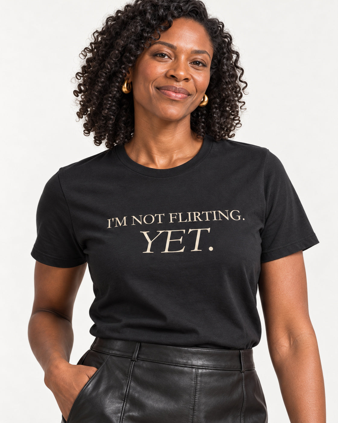 Close-up of I'm Not Flirting Yet printed on the black Bella Canvas 3001 T-shirt