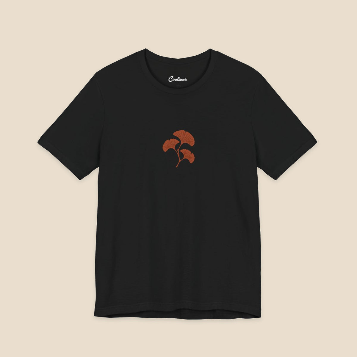 Black Bella+Canvas 3001 T-shirt with an original small rust three-leaf ginkgo twig graphic.