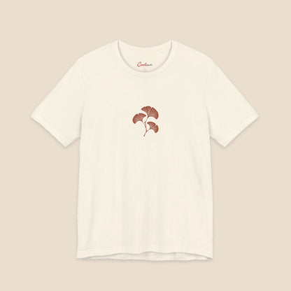Natural Bella+Canvas 3001 T-shirt with an original small rust three-leaf ginkgo twig graphic.