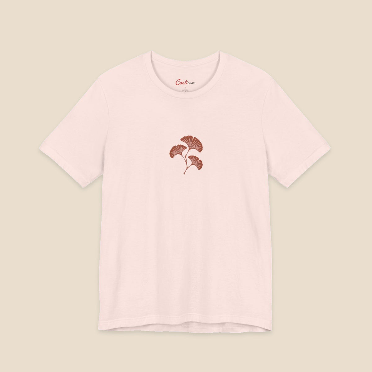 Soft Pink Bella+Canvas 3001 T-shirt with an original small rust three-leaf ginkgo twig graphic.