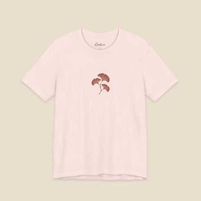 Soft Pink Bella+Canvas 3001 T-shirt with an original small rust three-leaf ginkgo twig graphic.