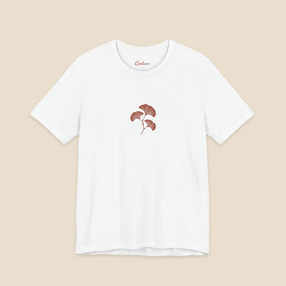 White Bella+Canvas 3001 T-shirt with an original small rust three-leaf ginkgo twig graphic.