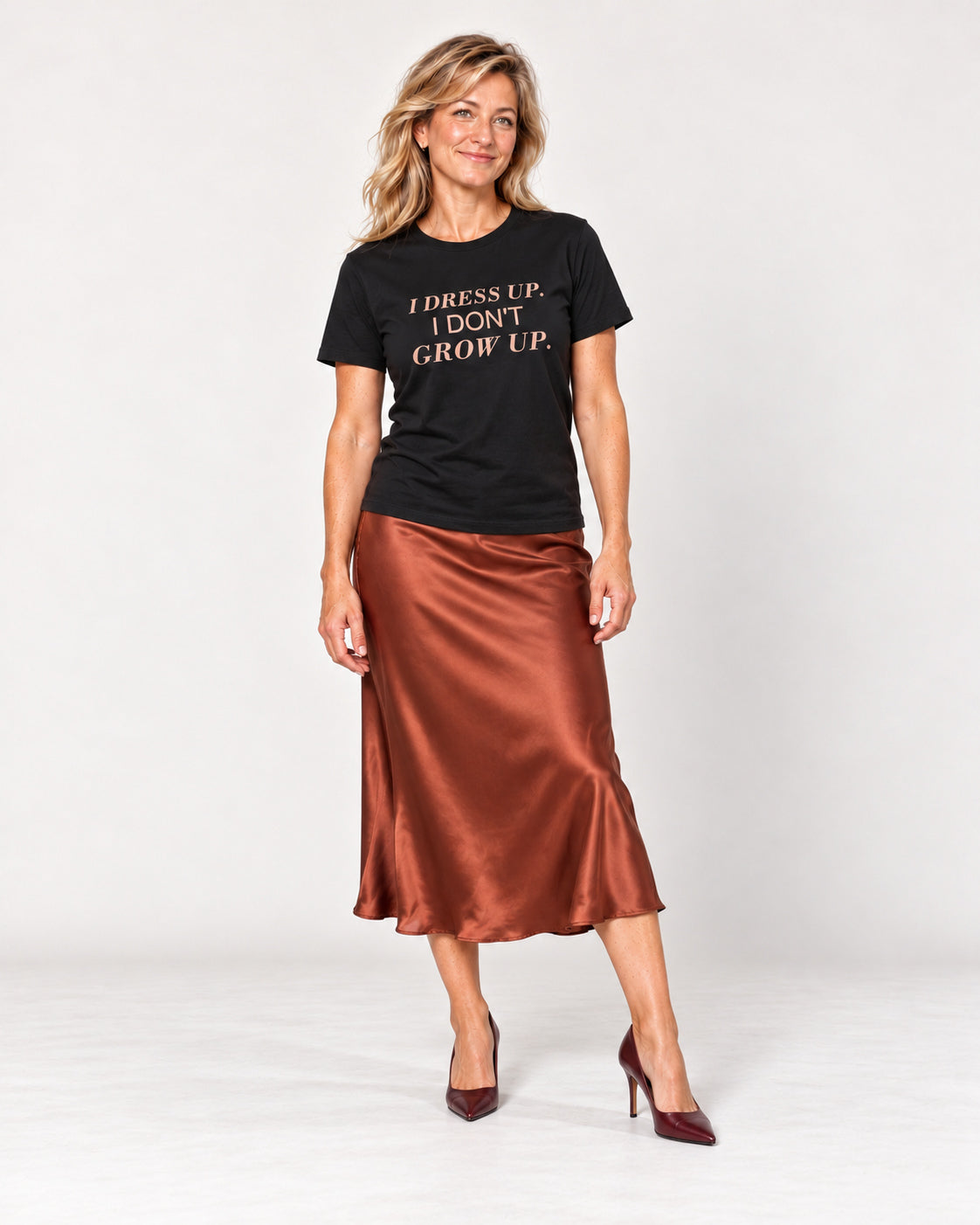 Elena wearing the Black I DRESS UP. I DON'T GROW UP. Bella+Canvas 3001 tee — full-length natural studio outfit