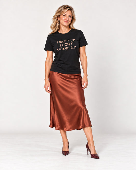 Elena wearing the Black I DRESS UP. I DON'T GROW UP. Bella+Canvas 3001 tee — full-length natural studio outfit