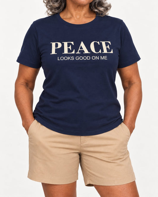 Vivienne wearing the Navy Her Peace Suits Her. Bella+Canvas 3001 tee — collar-to-hip detail with ink following fabric folds