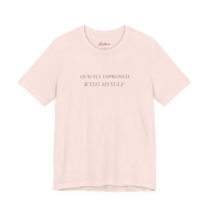Quietly Impressed With Myself Bella+Canvas 3001 T-shirt in Soft Pink, full front supplier flat lay.