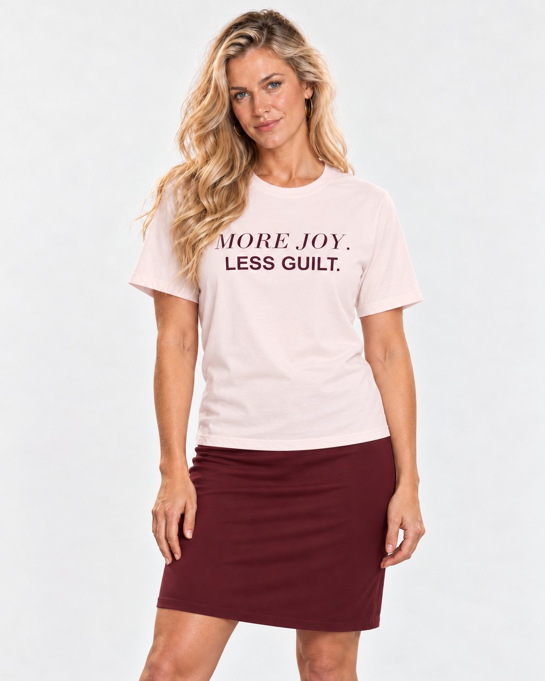 Chloe wearing the Soft Pink She Deserves the Good Bit. Bella+Canvas 3001 tee — natural studio portrait