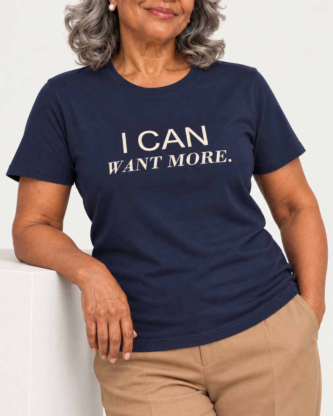 Vivienne wearing the Navy I CAN WANT MORE. Bella+Canvas 3001 tee — collar-to-hip print detail