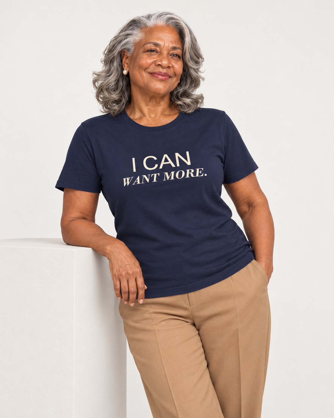 Vivienne wearing the Navy I CAN WANT MORE. Bella+Canvas 3001 tee in a natural studio portrait