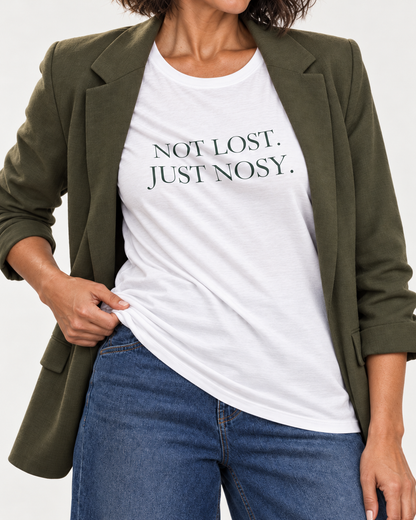 Close-up of dark green Not Lost. Just Nosy. lettering following folds on the white crewneck T-shirt.