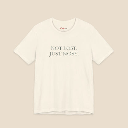 Natural Bella+Canvas3001 T-shirt with the two-line Not Lost. Just Nosy. chest design.