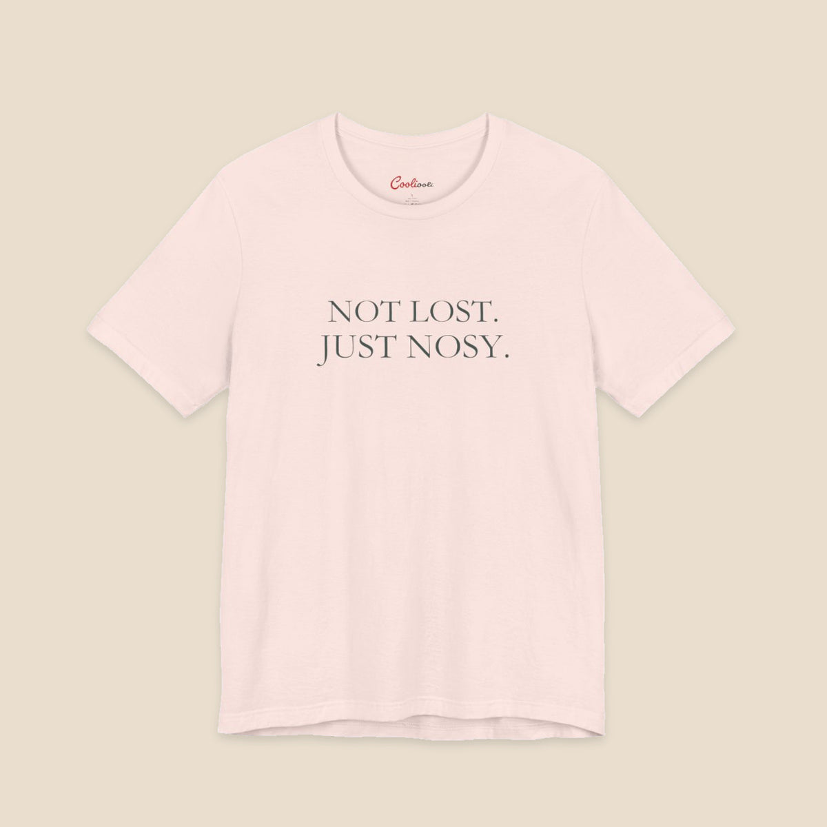 Soft Pink Bella+Canvas3001 T-shirt with the two-line Not Lost. Just Nosy. chest design.