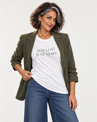 Freya wearing the white Not Lost. Just Nosy. Bella+Canvas3001 T-shirt with an open olive blazer and indigo jeans.