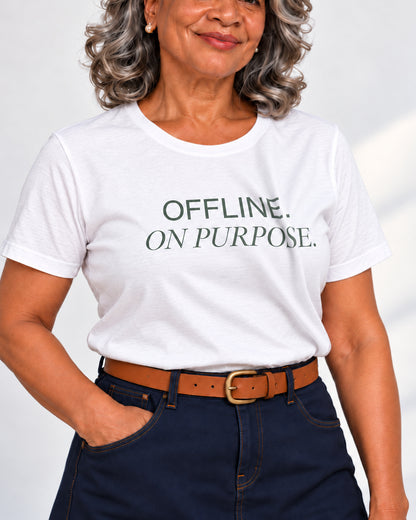 Close-up of OFFLINE. ON PURPOSE. sage lettering following the folds of the white T-shirt.