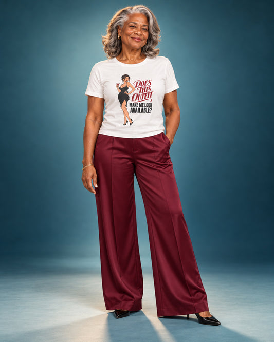 Vivienne wears the White Cooliooli Does This Outfit Make Me Look Available tee with burgundy wide-leg trousers and black pointed heels in a professional studio photoshoot.