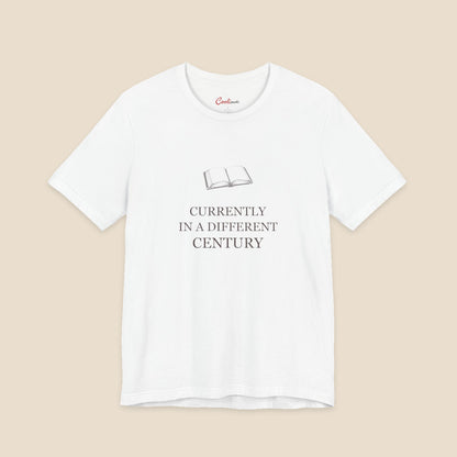 White Bella+Canvas 3001 reader T-shirt with an original open-book illustration and Currently in a Different Century lettering.