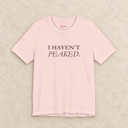 I Haven't Peaked Bella+Canvas 3001 T-shirt in Soft Pink, front flat lay.